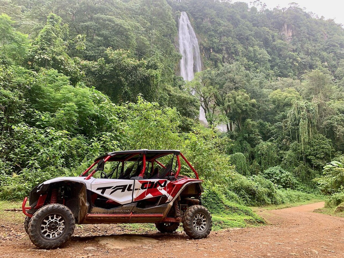 Honda Talon ATV in front of a jungle waterfall on an excursion near Casa Cavu