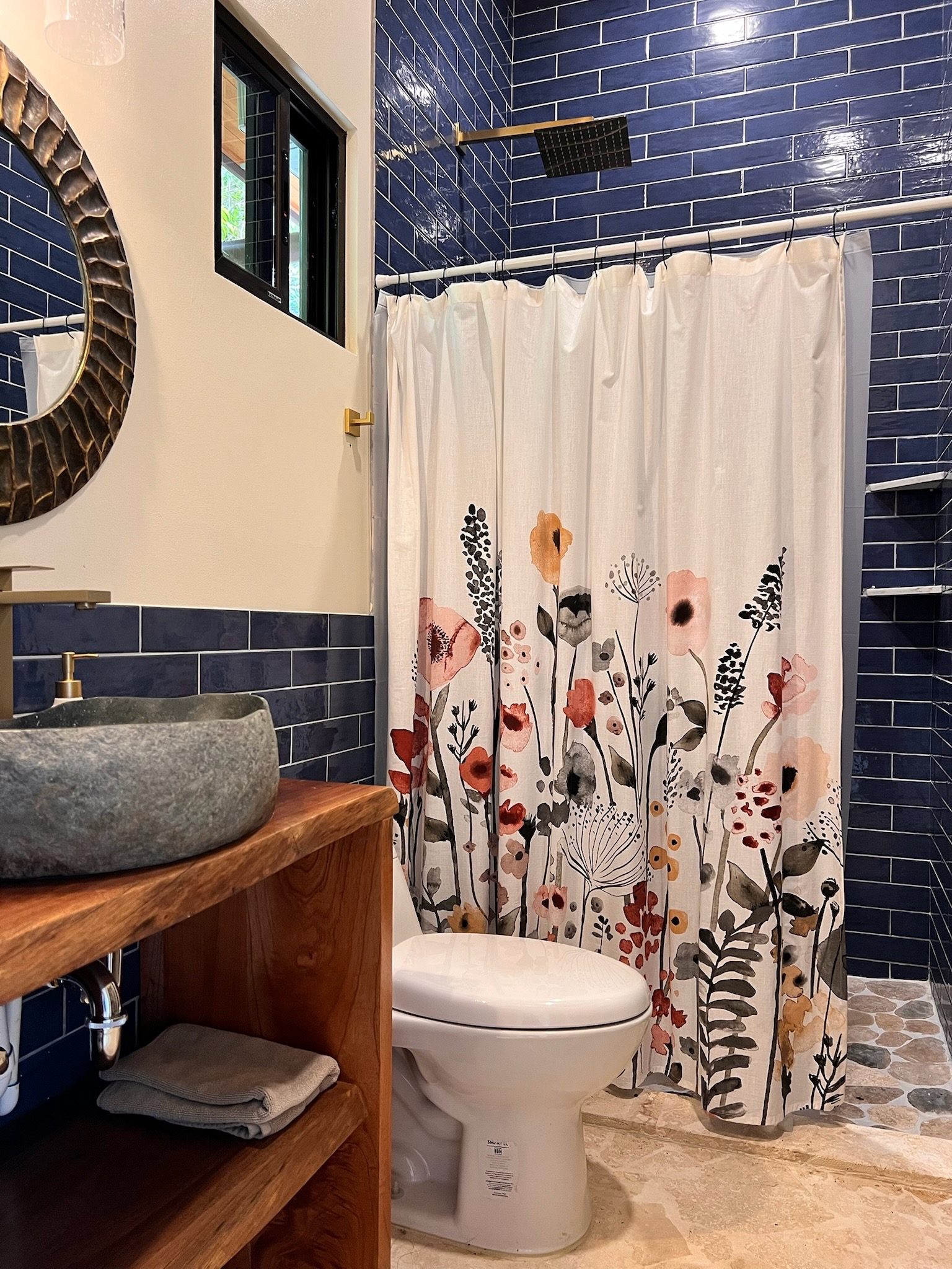 Blue-tile bath with river-stone vessel sink