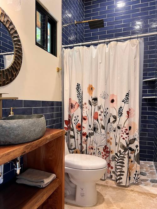Blue-tile bath with river-stone vessel sink