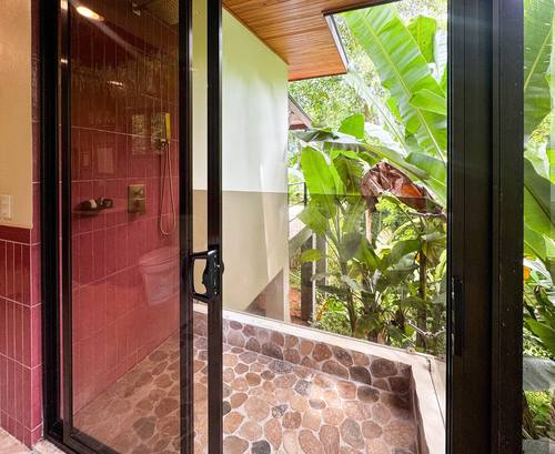 Terracotta shower opening to banana plants