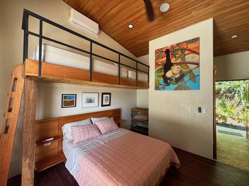 Bedroom with red cedar headboard and hardwood floors