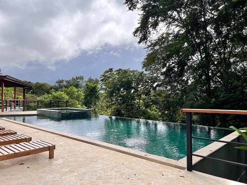 Teak loungers beside the infinity pool